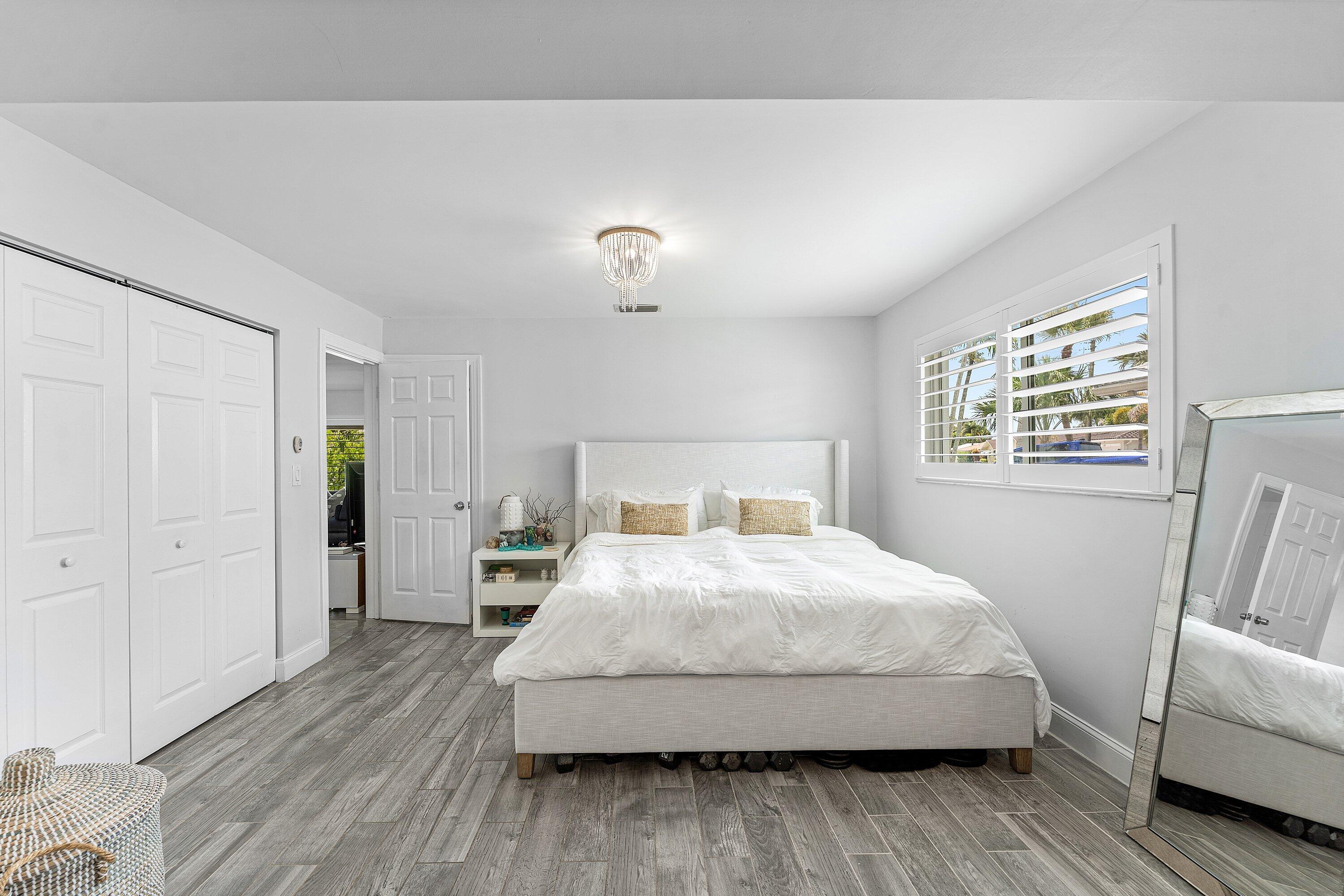 581 Northwest 13th Drive Boca Raton, FL 33486 - Photo 23 of 39 a bedroom with a bed and a couch