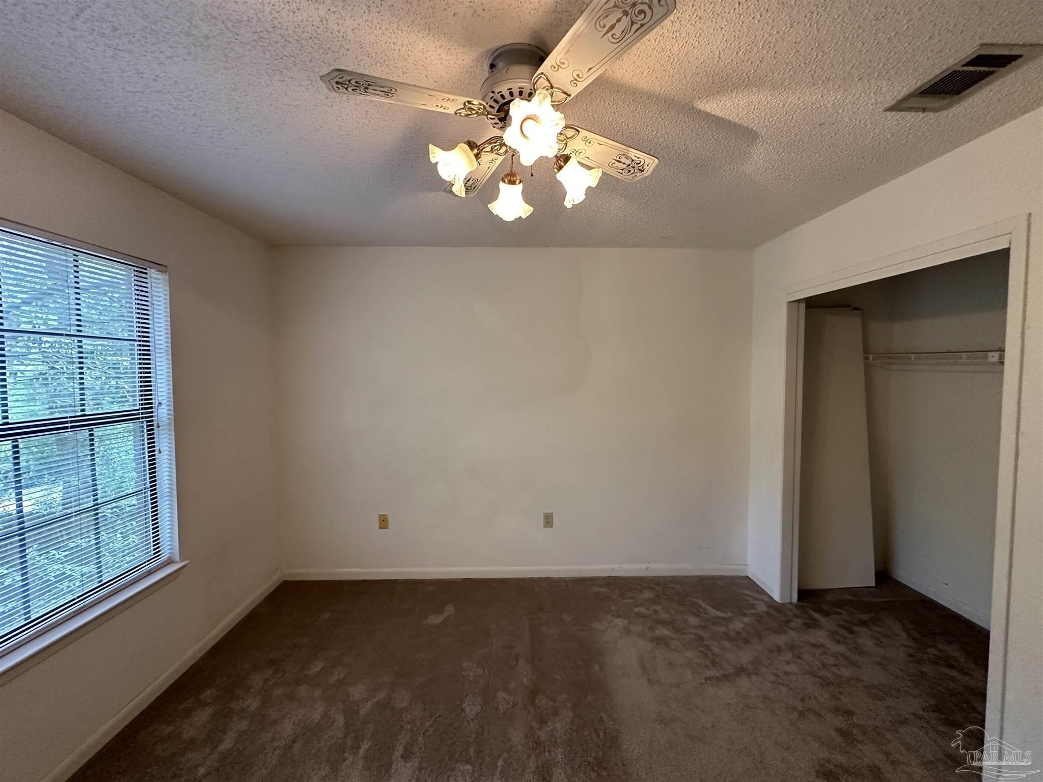 511 Maple Avenue Niceville, FL 32578 - Photo 14 of 17 wooden floor in an empty room with a window