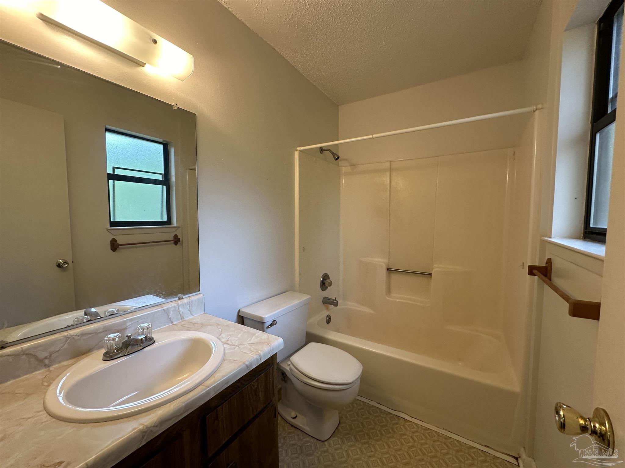 511 Maple Avenue Niceville, FL 32578 - Photo 16 of 17 a bathroom with a sink a toilet and shower