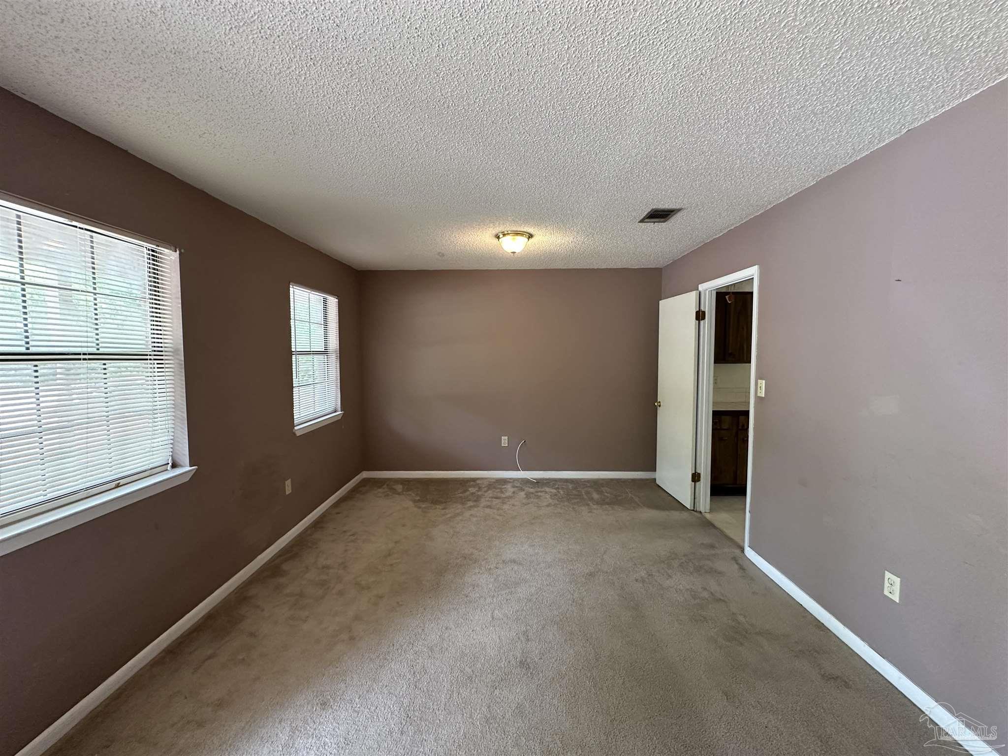 511 Maple Avenue Niceville, FL 32578 - Photo 2 of 17 an empty room with windows