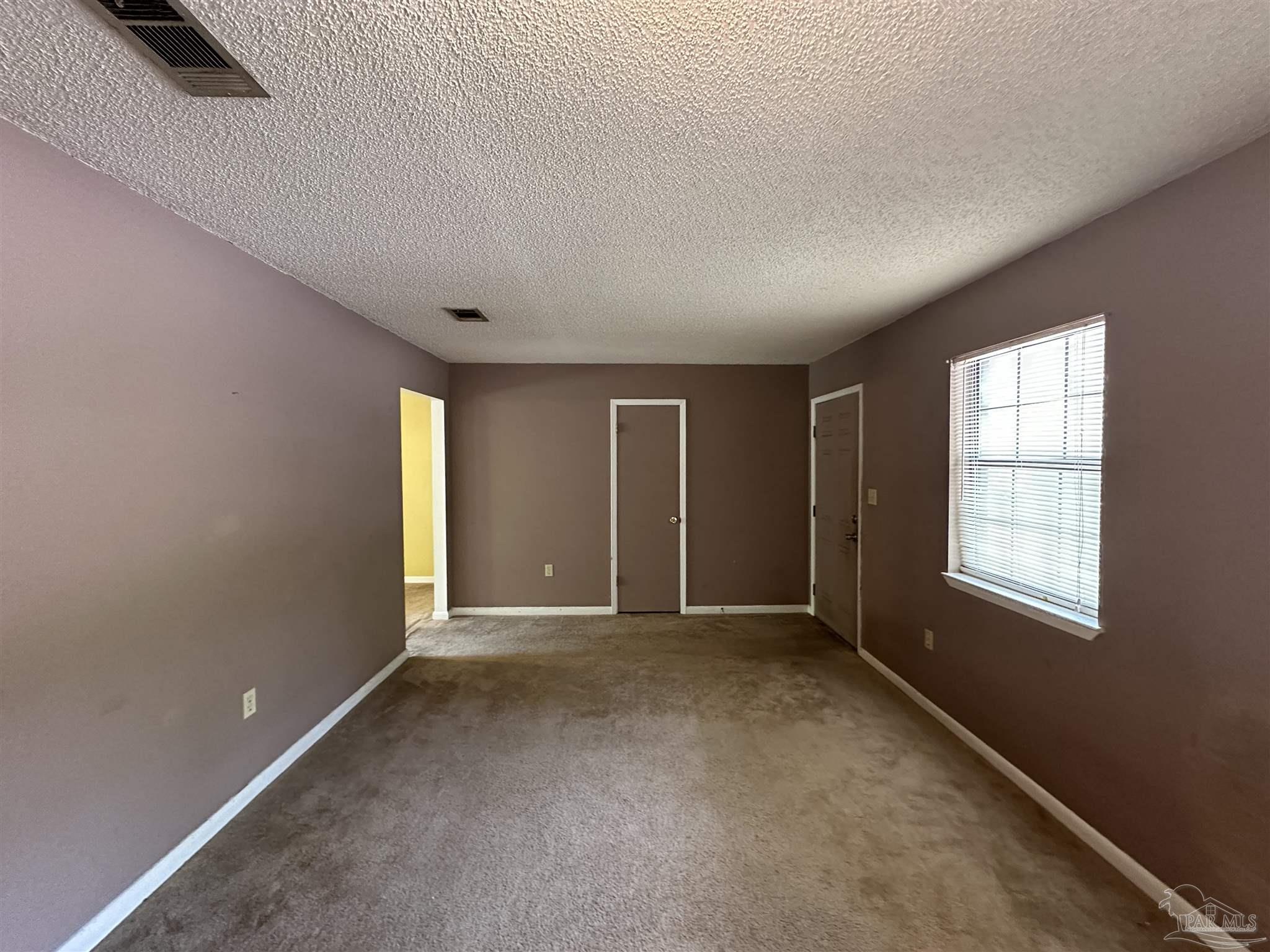 511 Maple Avenue Niceville, FL 32578 - Photo 3 of 17 an empty room with windows