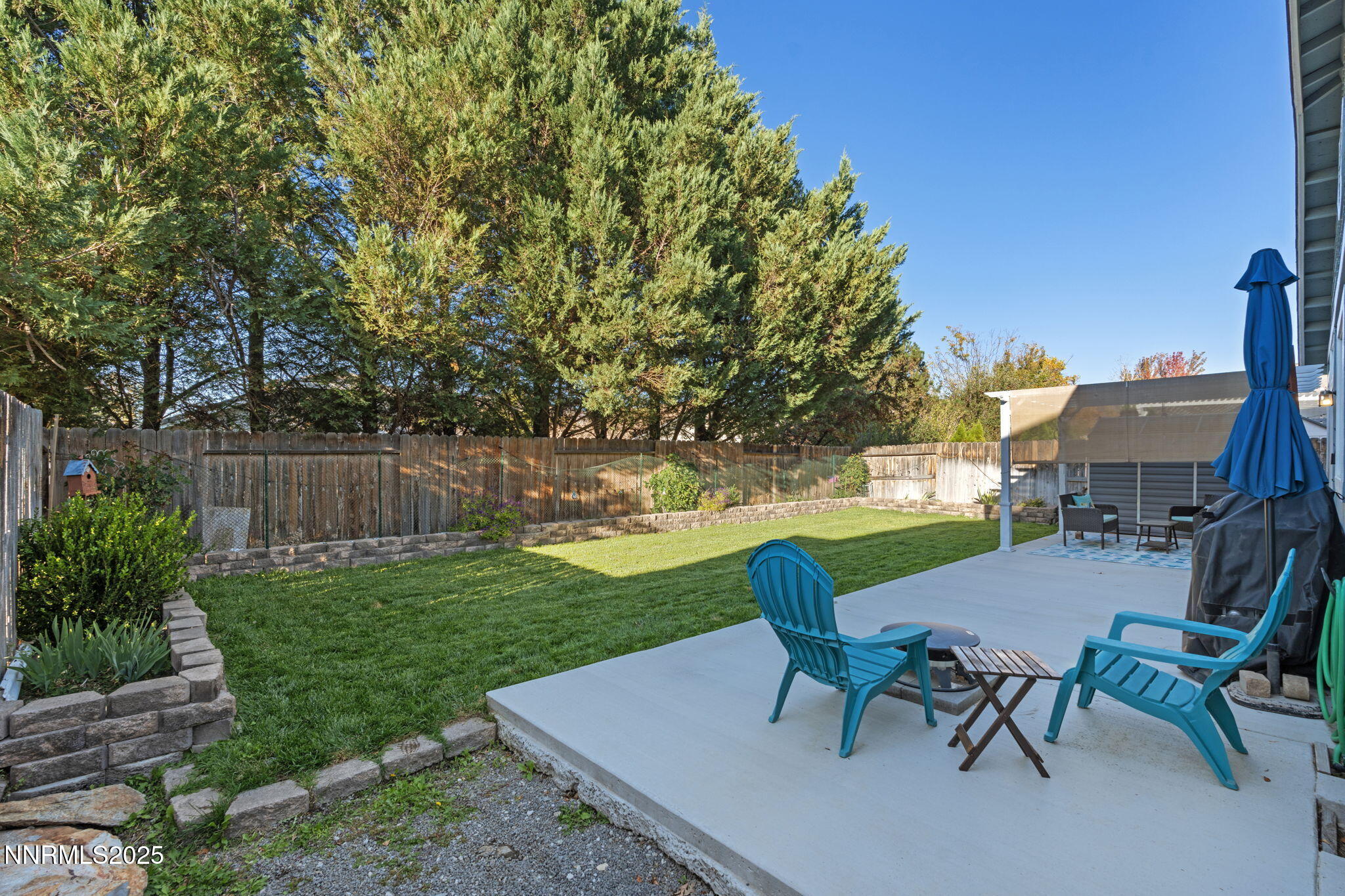 2155 Eagle Greens Drive Reno, NV 89521 - Photo 29 of 31 a view of a patio with table and chairs and potted plants with wooden fence
