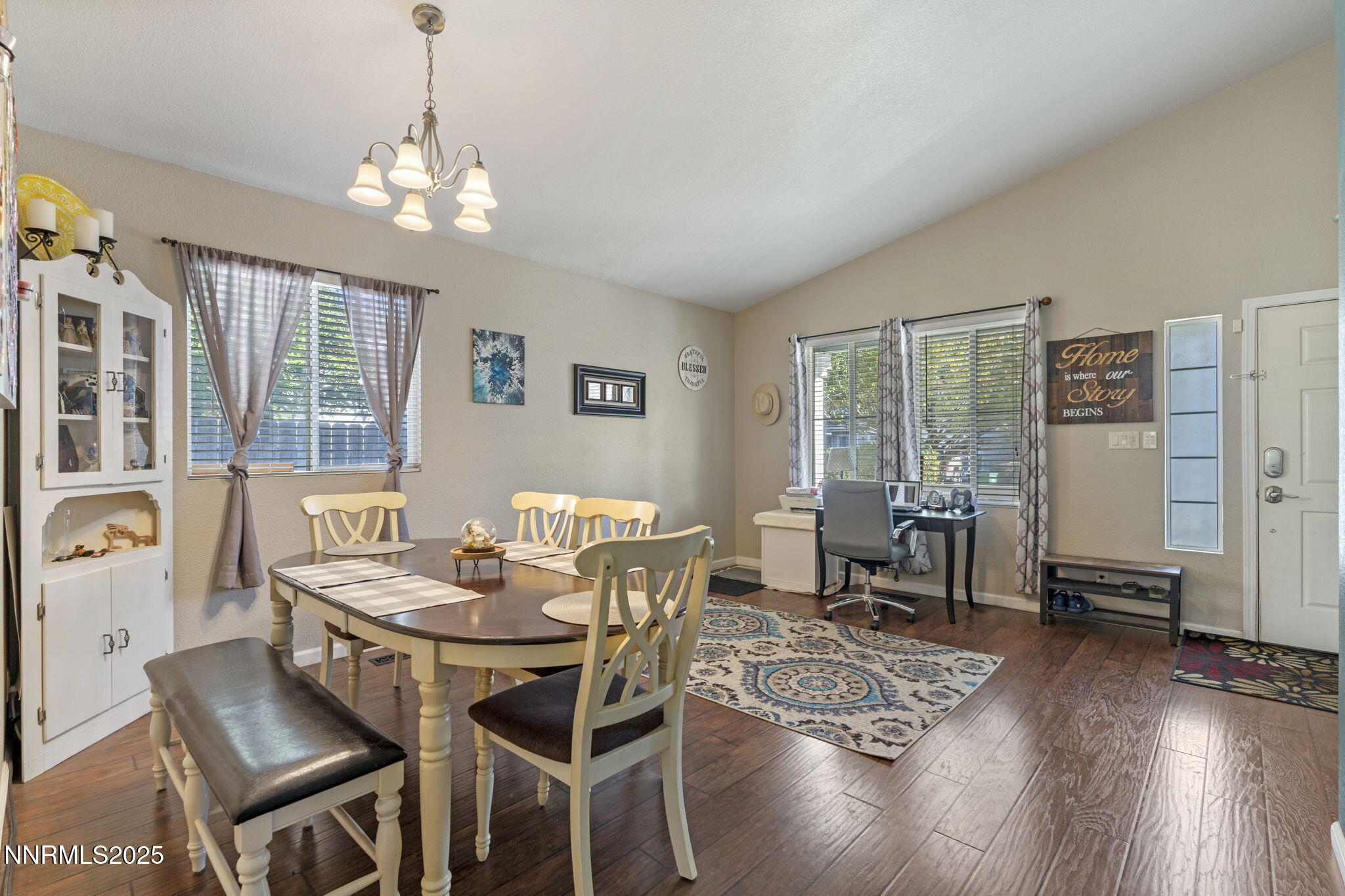 2155 Eagle Greens Drive Reno, NV 89521 - Photo 3 of 31 a dining room with wooden floor a chandelier a wooden table and chairs