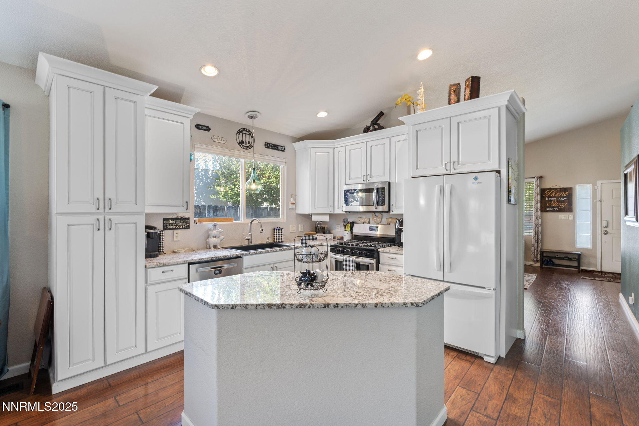 2155 Eagle Greens Drive Reno, NV 89521 - Photo 8 of 31 a kitchen with stainless steel appliances granite countertop a refrigerator a sink dishwasher a stove and white cabinets with wooden floor
