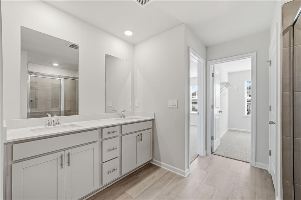 1503 Wild Fox Run Lawrenceville, GA 30045 - Photo 21 of 46 a spacious bathroom with a double vanity sink mirror and