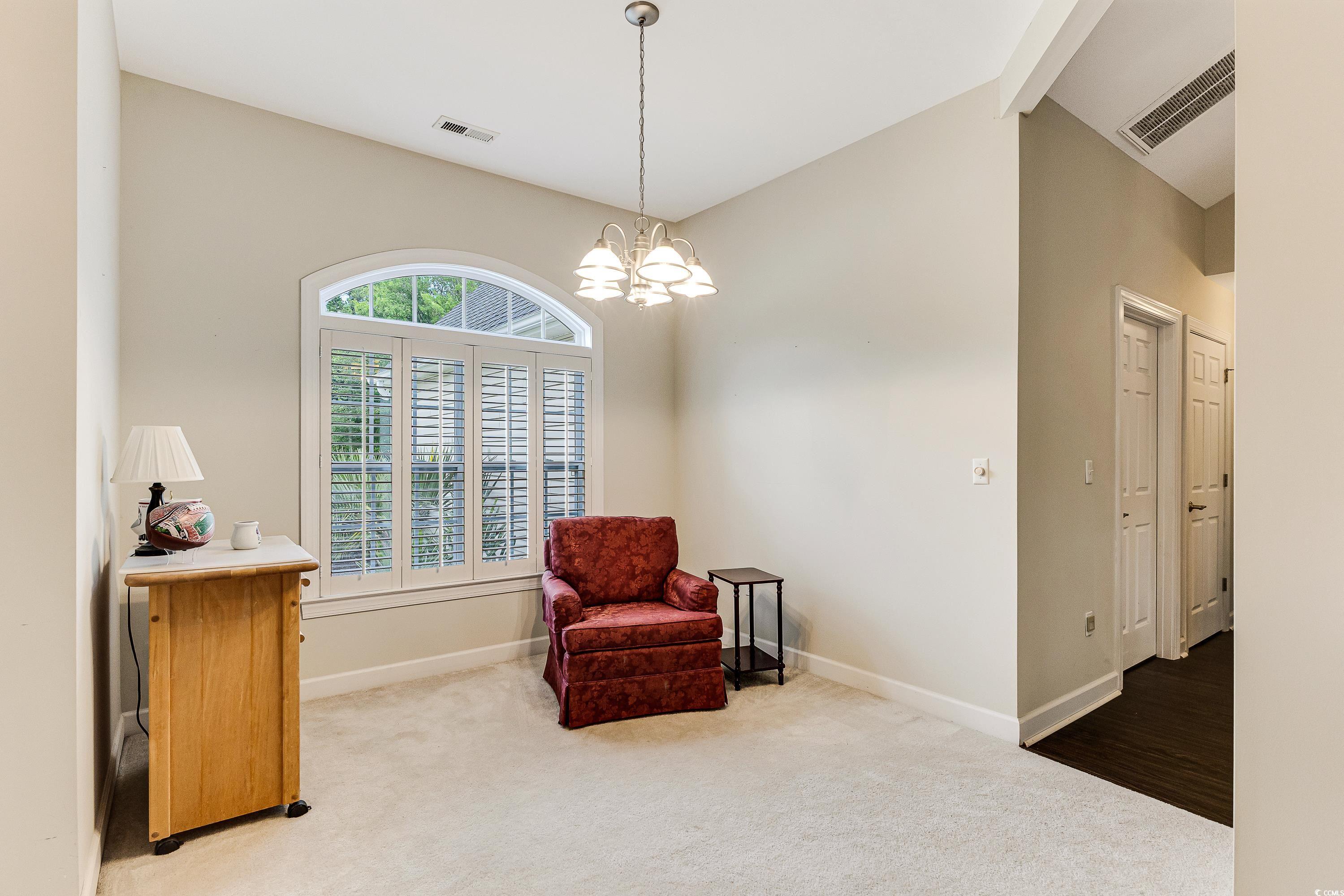 101 Cedar Tree Lane Southwest Calabash, NC 28467 - Photo 12 of 40 Sitting room with carpet flooring and a chandelier
