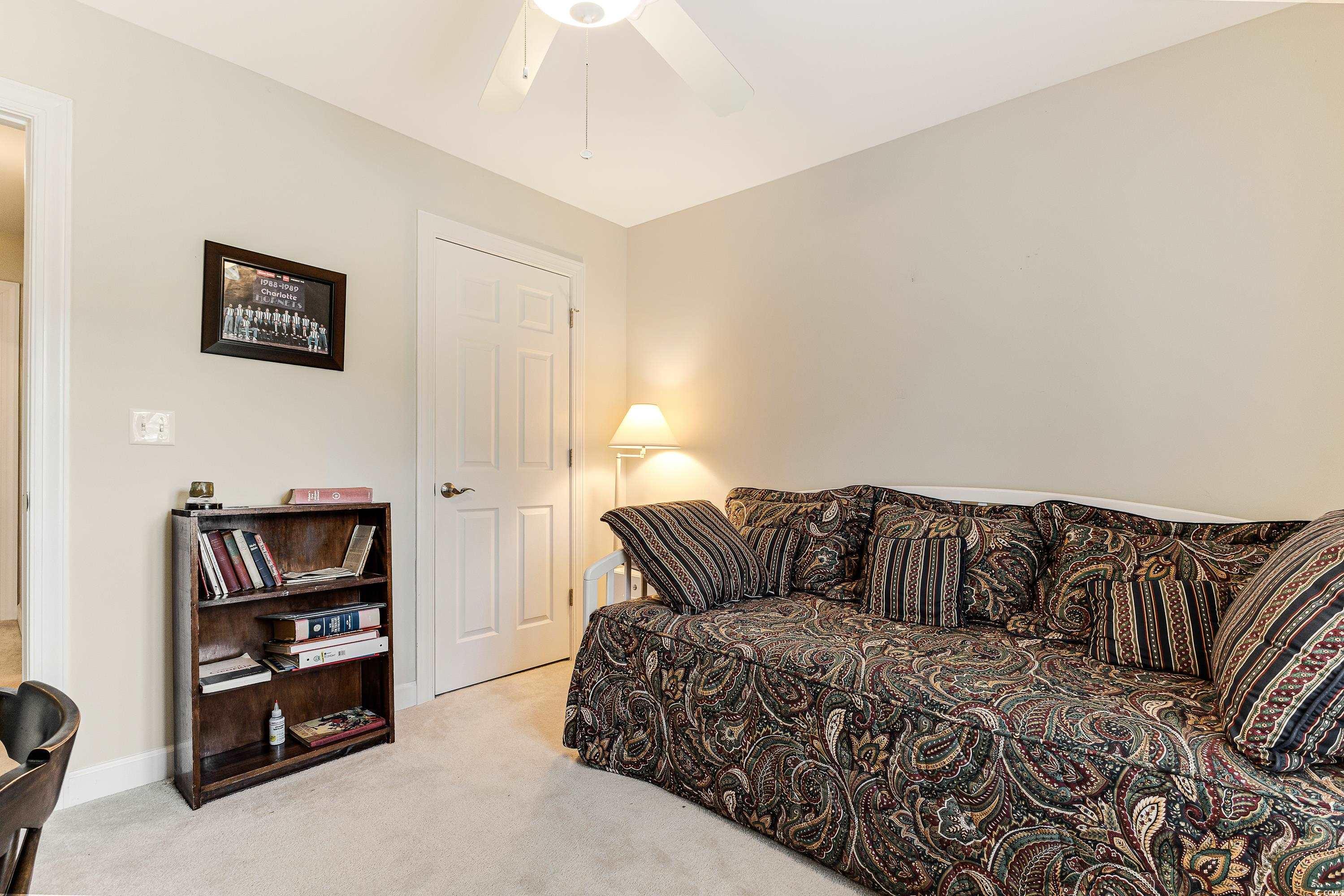 101 Cedar Tree Lane Southwest Calabash, NC 28467 - Photo 26 of 40 Living area featuring carpet floors and ceiling fan