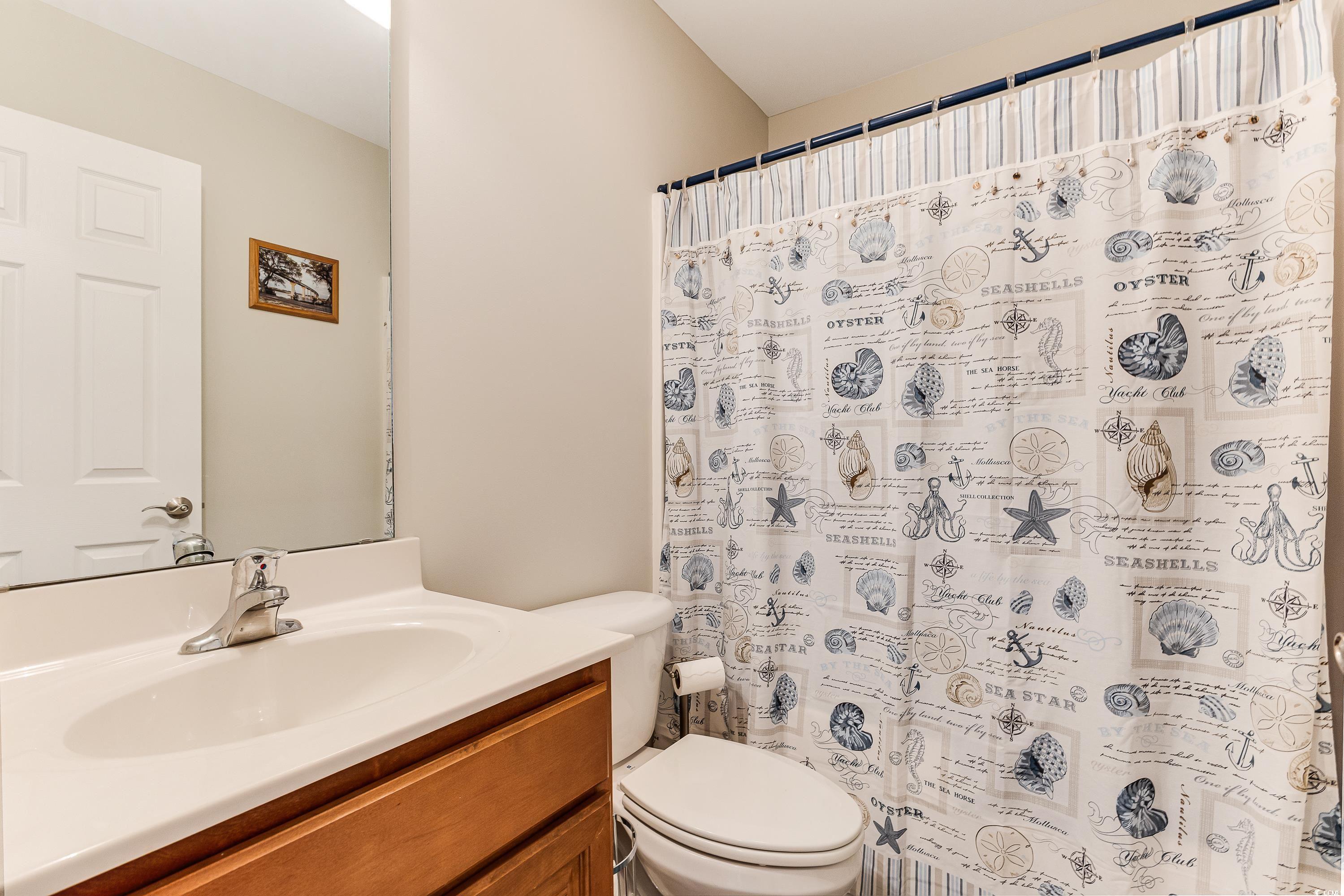 101 Cedar Tree Lane Southwest Calabash, NC 28467 - Photo 27 of 40 Bathroom with vanity and a shower with shower curtain