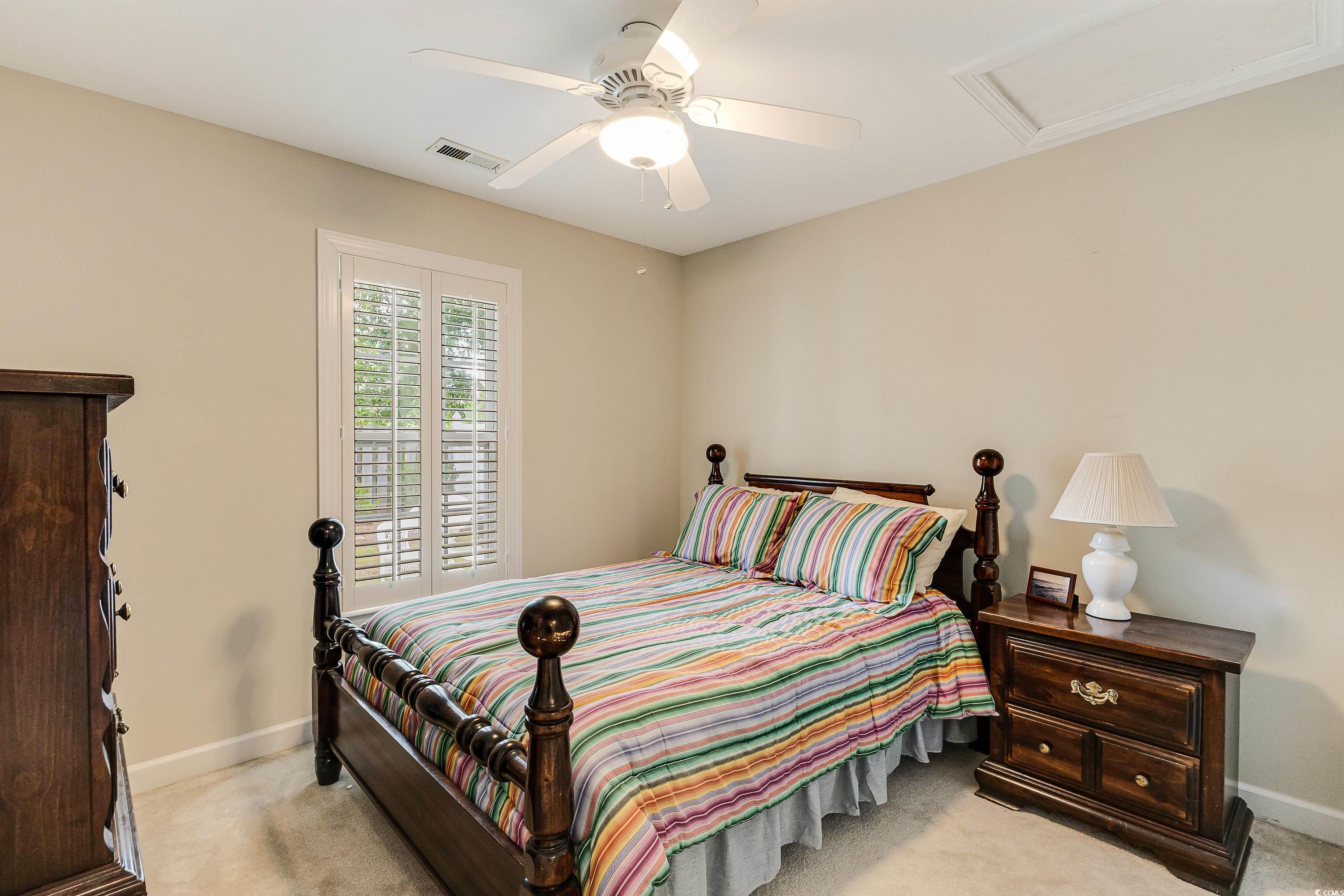 101 Cedar Tree Lane Southwest Calabash, NC 28467 - Photo 28 of 40 Carpeted bedroom featuring attic access and ceiling fan