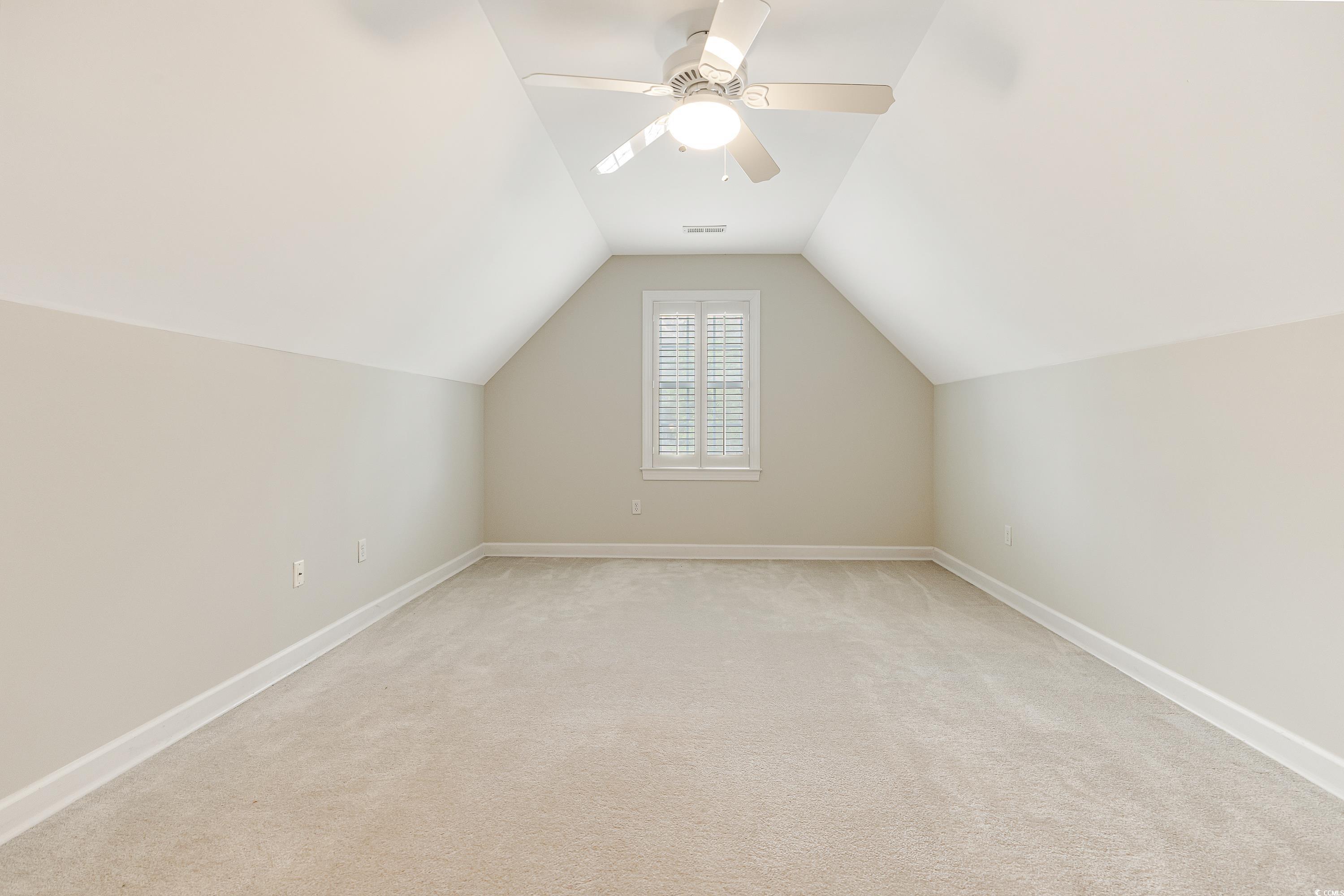 101 Cedar Tree Lane Southwest Calabash, NC 28467 - Photo 30 of 40 Additional living space with lofted ceiling, light colored carpet, and ceiling fan