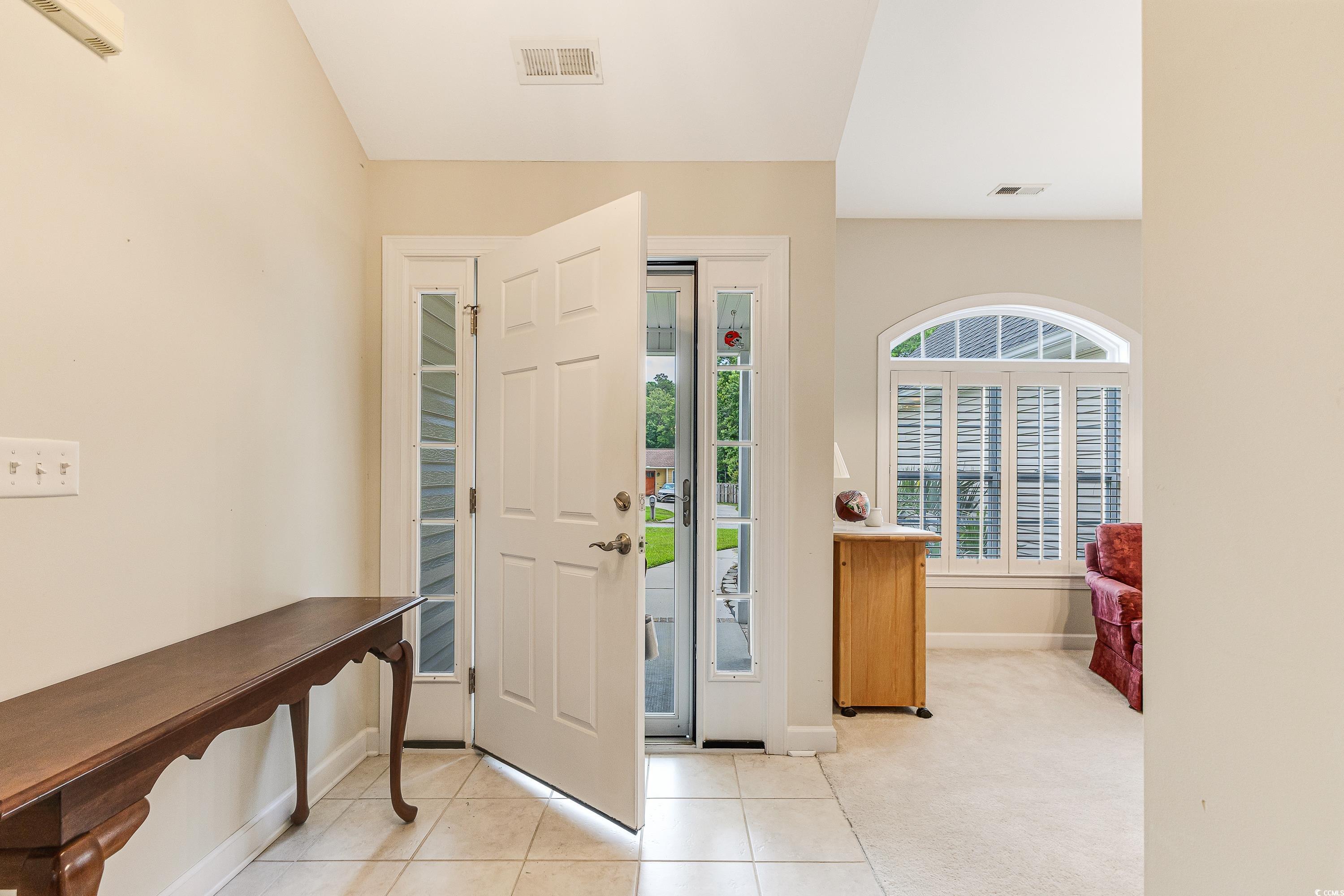 101 Cedar Tree Lane Southwest Calabash, NC 28467 - Photo 5 of 40 Foyer entrance with light tile patterned flooring and lofted ceiling