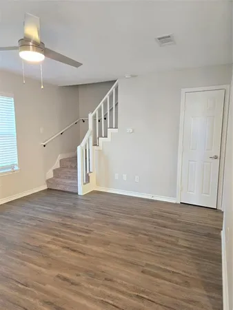 a view of an entryway with wooden floor