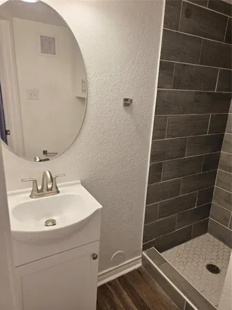 a bathroom with a sink toilet and shower