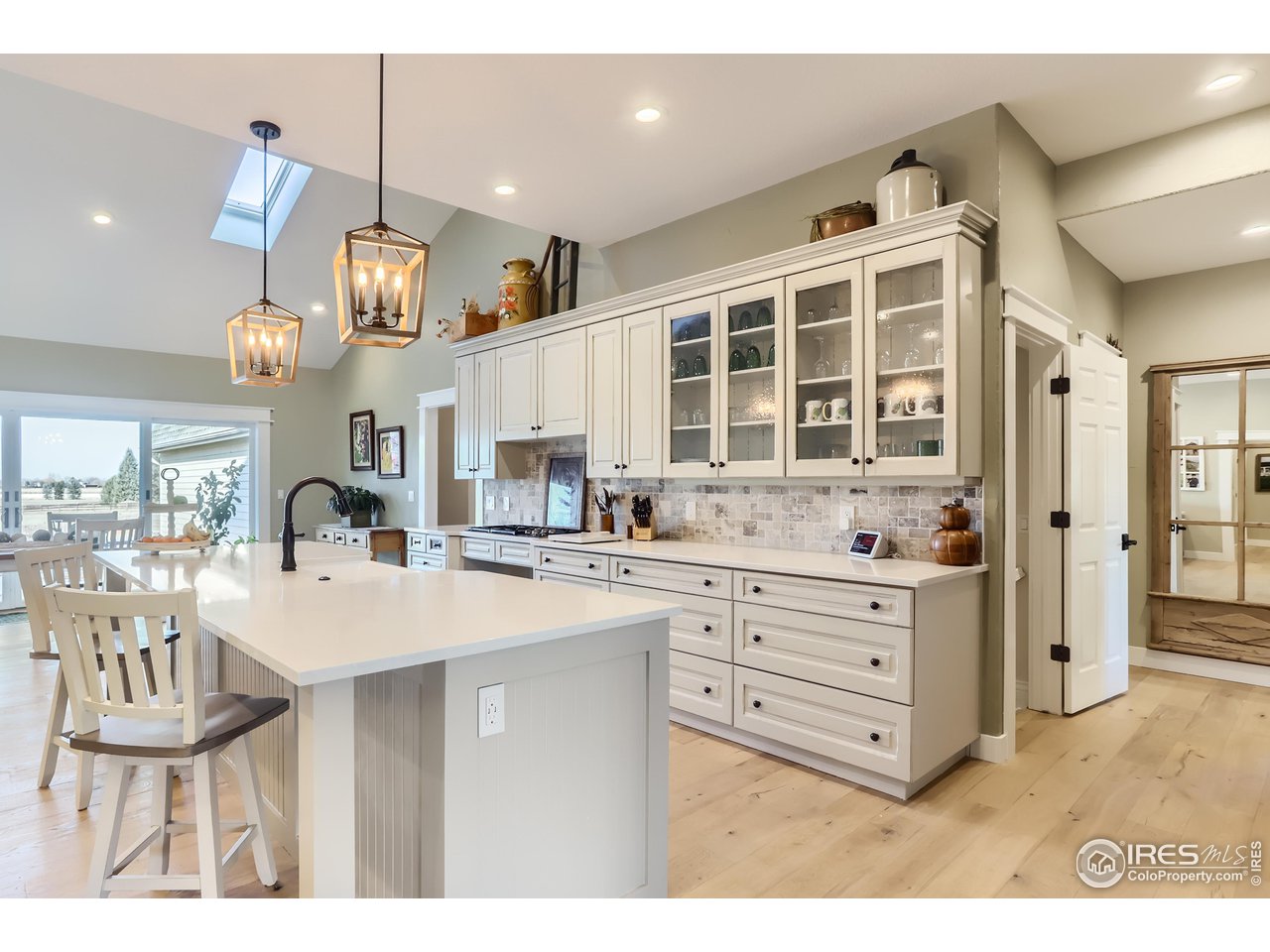8435 Brittany Place Niwot, CO 80503 - Photo 13 of 40 a kitchen with granite countertop a white stove top oven and cabinets