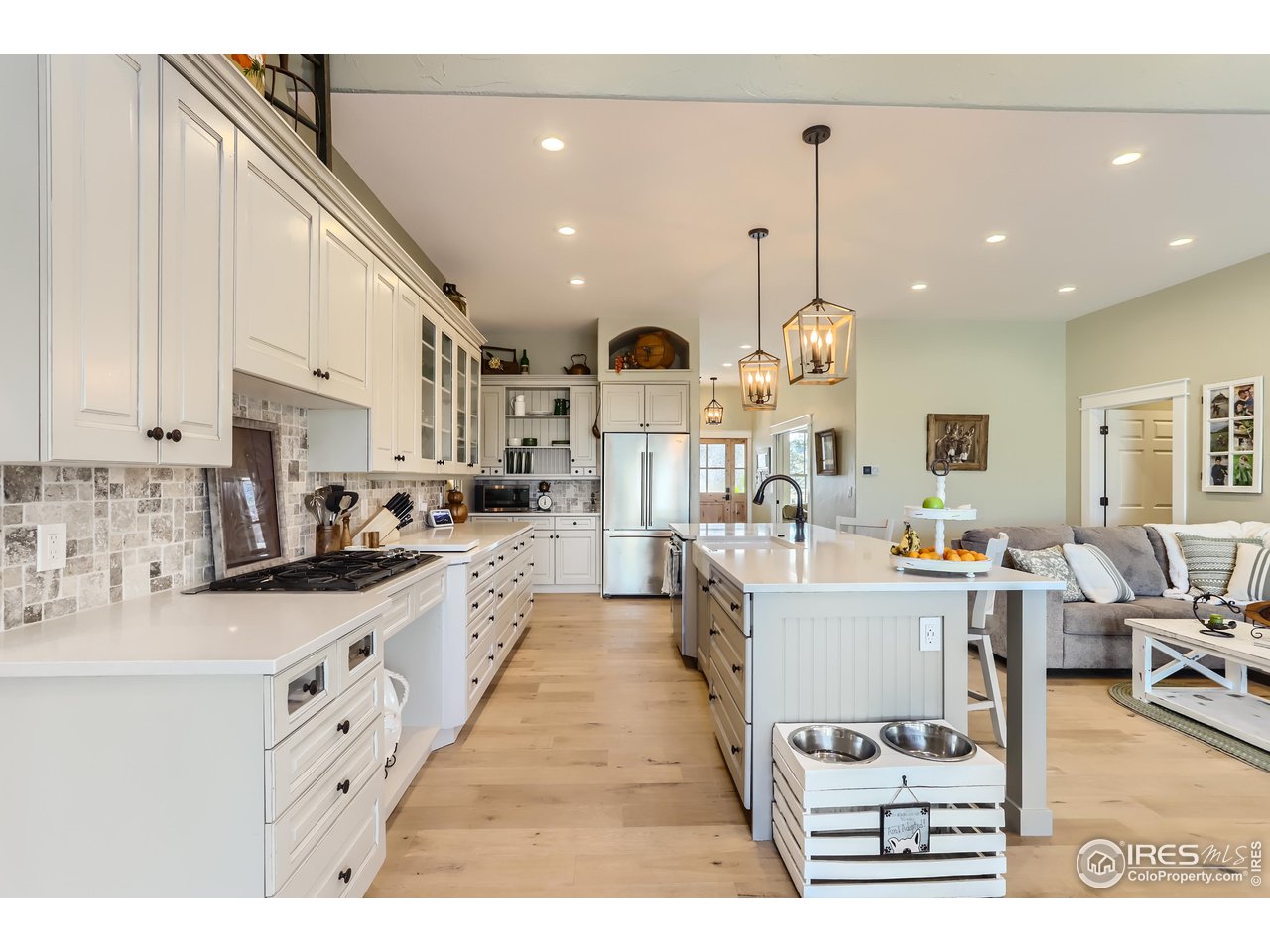 8435 Brittany Place Niwot, CO 80503 - Photo 15 of 40 a large white kitchen with lots of counter space and chandelier