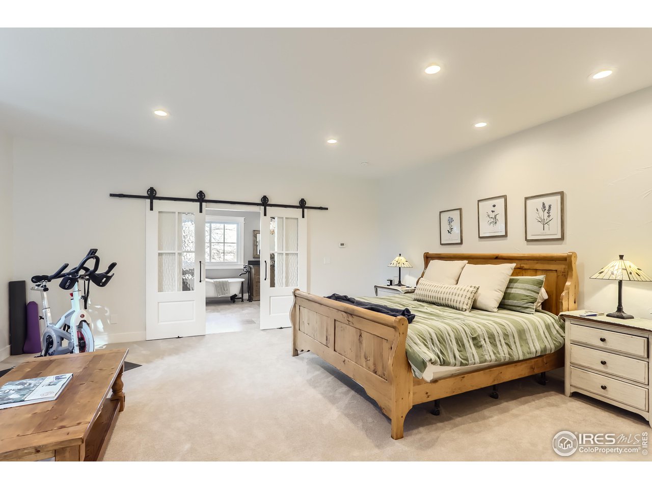 8435 Brittany Place Niwot, CO 80503 - Photo 19 of 40 a bedroom with a bed and a large mirror