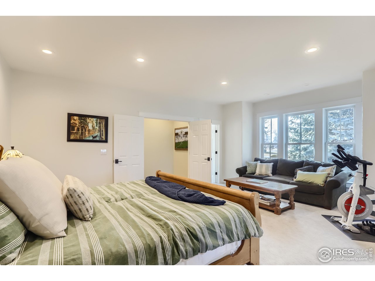 8435 Brittany Place Niwot, CO 80503 - Photo 20 of 40 a bedroom with a bed a couch and a large window