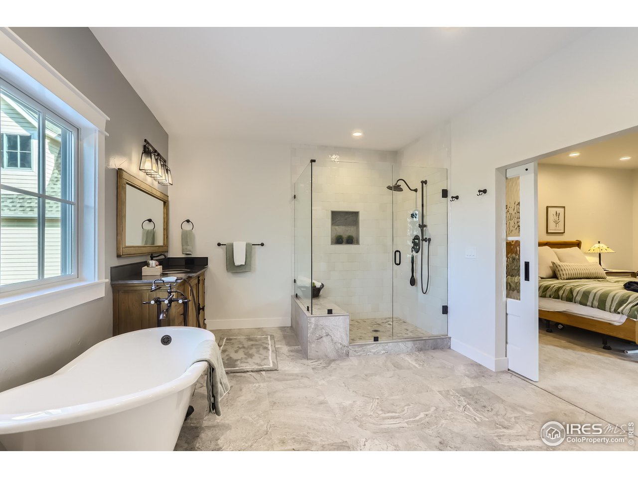 8435 Brittany Place Niwot, CO 80503 - Photo 22 of 40 a bathroom with a tub sink and mirror