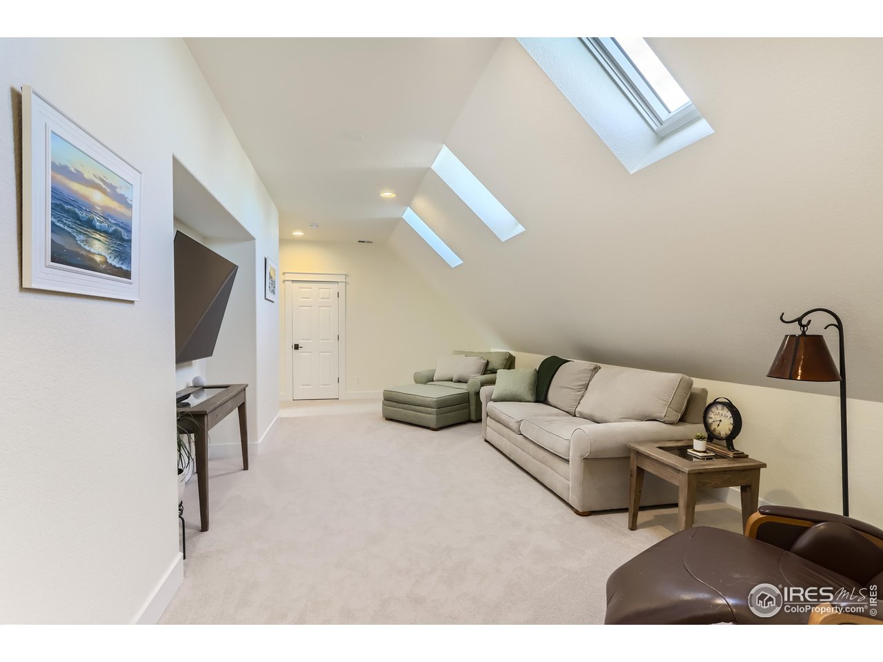 8435 Brittany Place Niwot, CO 80503 - Photo 24 of 40 a living room with furniture and a flat screen tv