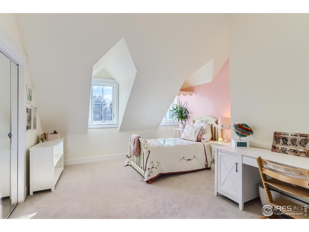 8435 Brittany Place Niwot, CO 80503 - Photo 26 of 40 a living room with furniture and a baby crib