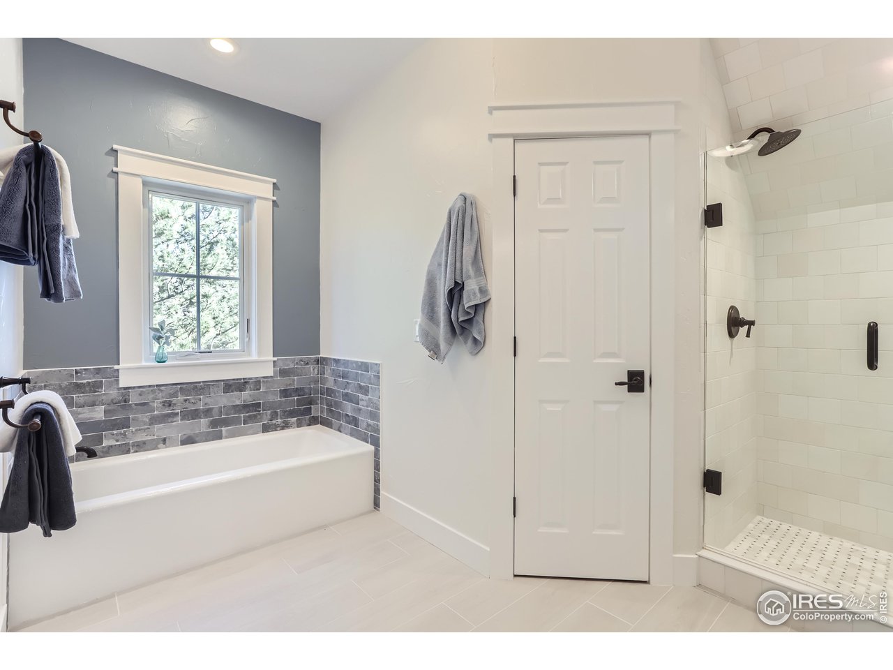 8435 Brittany Place Niwot, CO 80503 - Photo 28 of 40 a bathroom with a tub a sink and a window