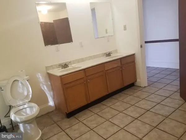 a bathroom with a toilet sink and mirror
