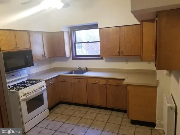 a kitchen with a stove a sink and a microwave
