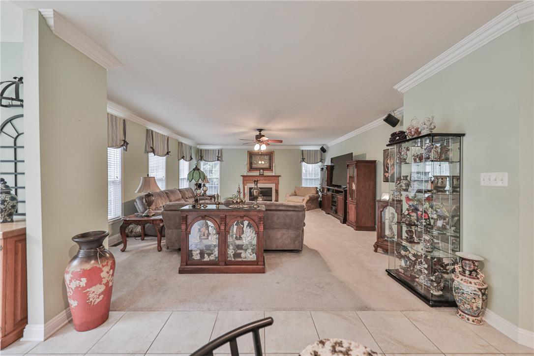 138 Clover Hollow Road Easton, PA 18045 - Photo 29 of 95 A generously sized living space featuring a cozy fireplace and abundant natural light from multiple windows.