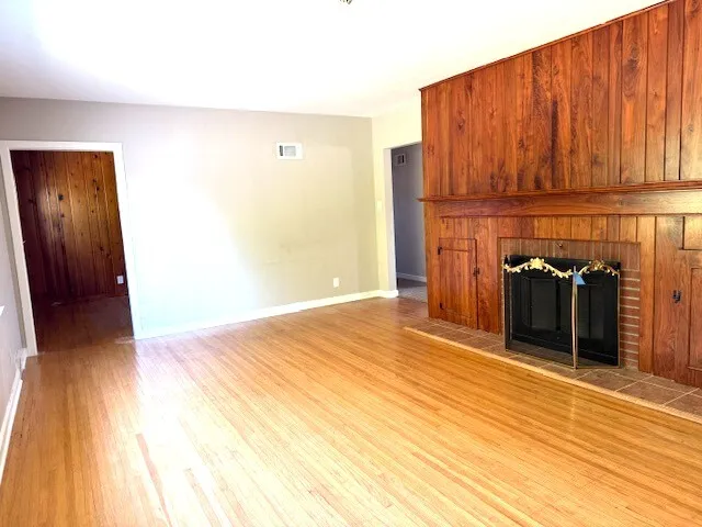 a view of a room with wooden floor