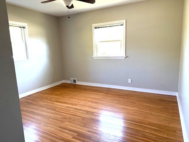 704 East 9th Street Lockport, IL 60441 - Photo 16 of 16 an empty room with wooden floor and windows