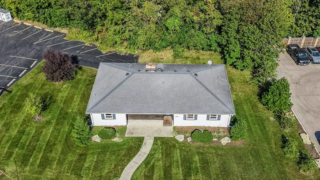 an aerial view of a house with a yard