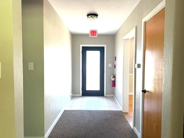 a view of a hallway view with wooden floor and closet
