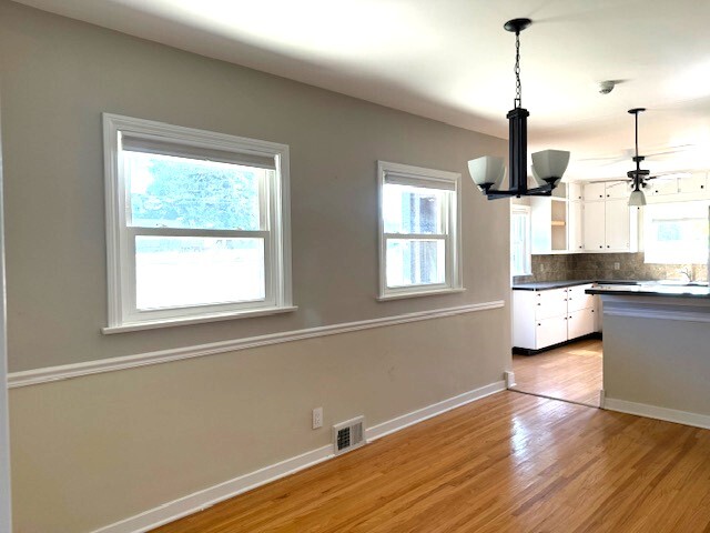 704 East 9th Street Lockport, IL 60441 - Photo 10 of 16 a kitchen with stainless steel appliances wooden floor and a window