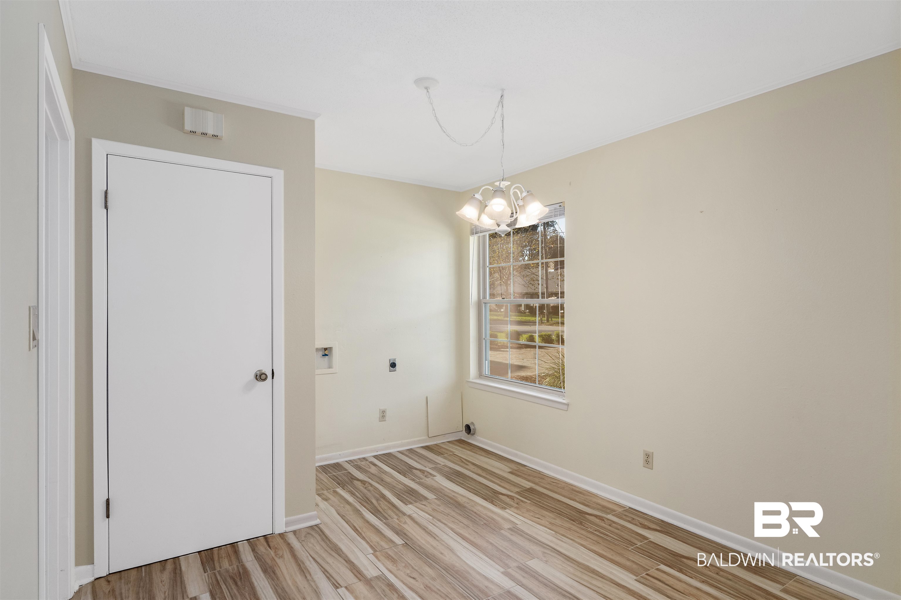 621 Spanish Main Spanish Fort, AL 36527 - Photo 18 of 29 Unfurnished room with a notable chandelier and light wood-type flooring