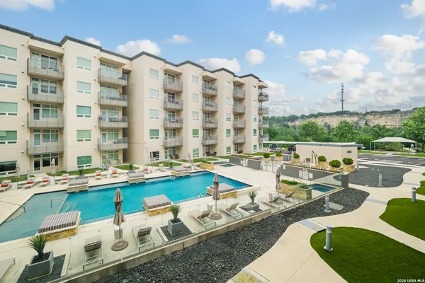 a view of a swimming pool with outdoor seating