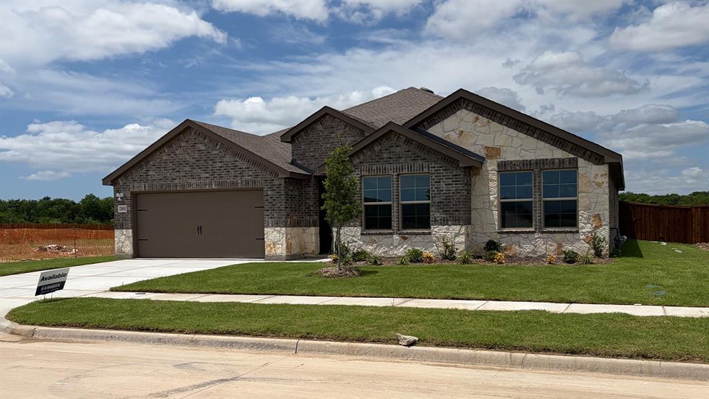 2003 Reveille Way Terrell, TX 75160 - Photo 2 of 25 Contemporary single-story residence showcasing a mixed-material facade of dark brick and light-toned stone