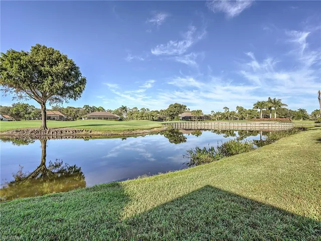 a view of a lake with houses in the background