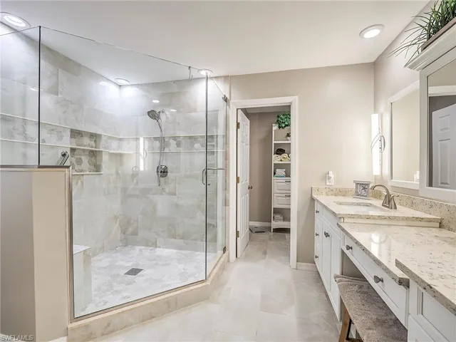 a bathroom with a granite countertop shower mirror and a sink