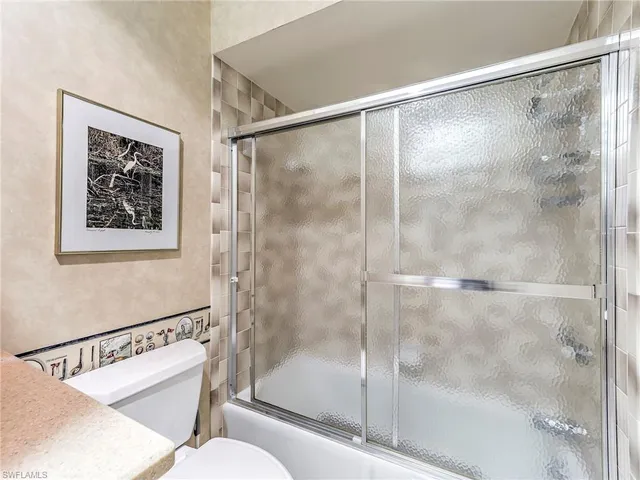 a bathroom with a shower and a toilet