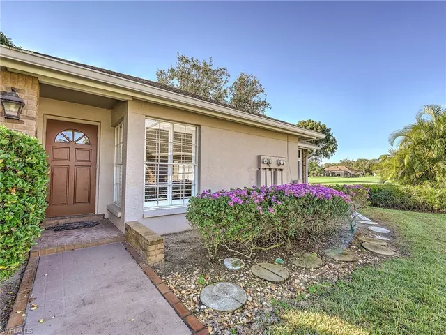 a front view of a house with plants