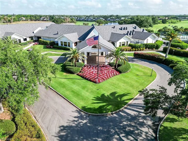 an aerial view of residential houses with outdoor space and trees