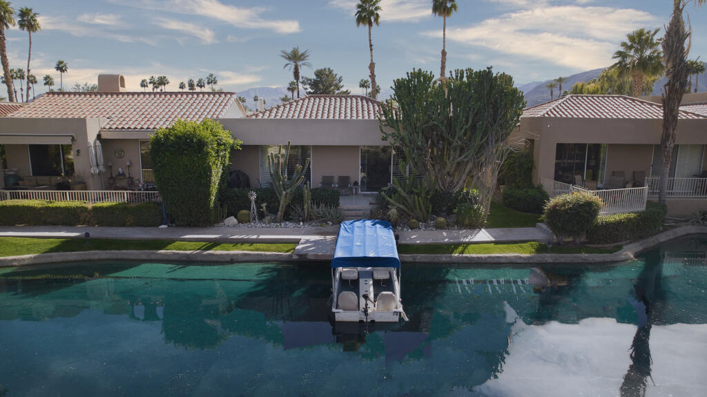 17 Lakeshore Drive Rancho Mirage, CA 92270 - Photo 1 of 23 a swimming pool with outdoor seating and yard