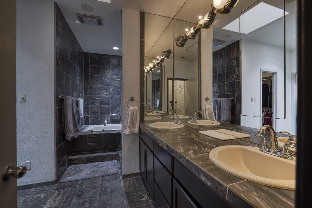 17 Lakeshore Drive Rancho Mirage, CA 92270 - Photo 18 of 23 a bathroom with a granite countertop sink a mirror and a shower