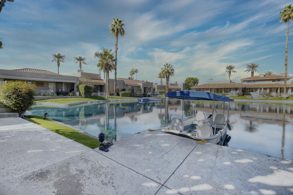 17 Lakeshore Drive Rancho Mirage, CA 92270 - Photo 4 of 23 a view of a lake with boats and a bridge