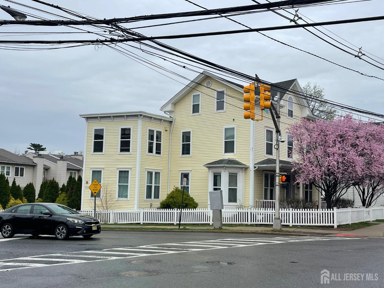 161 George Street New Brunswick, NJ 08901 - Photo 3 of 10 a view of a white building that has a car parked on the road