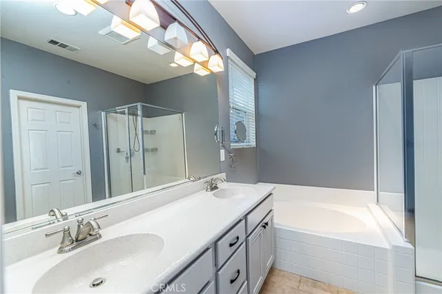 a bathroom with a tub sink and mirror