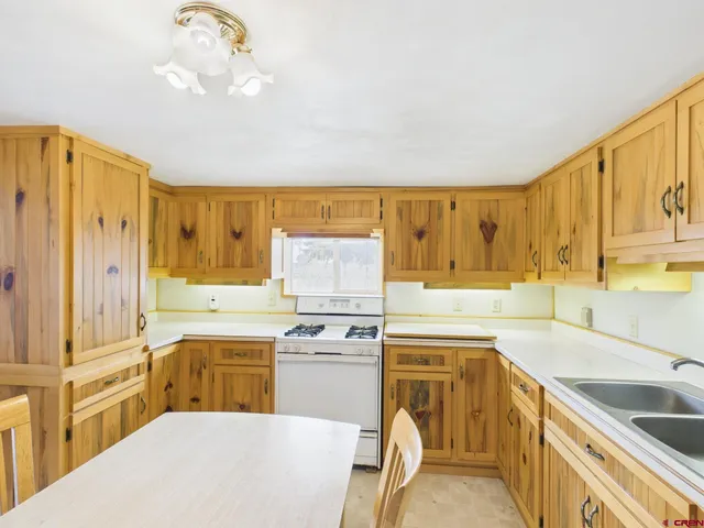 a kitchen with a sink cabinets and window