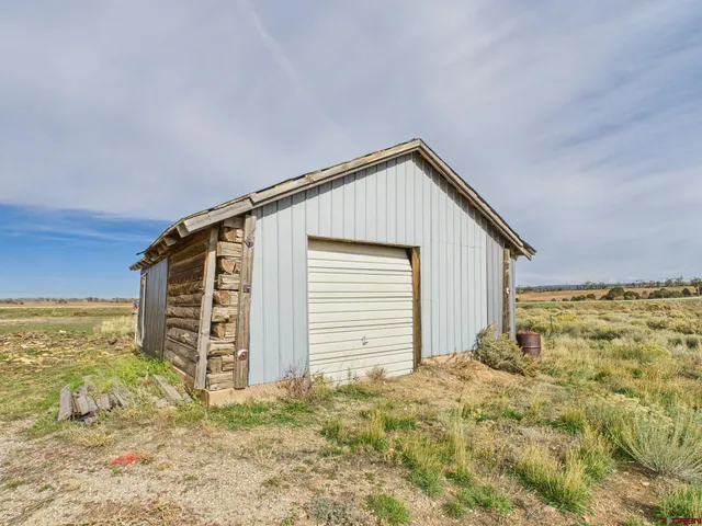 a view of house with backyard and garden
