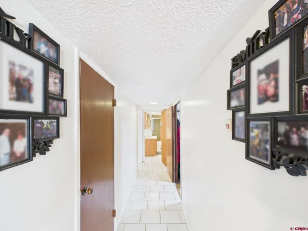 a view of a hallway with paintings on the wall