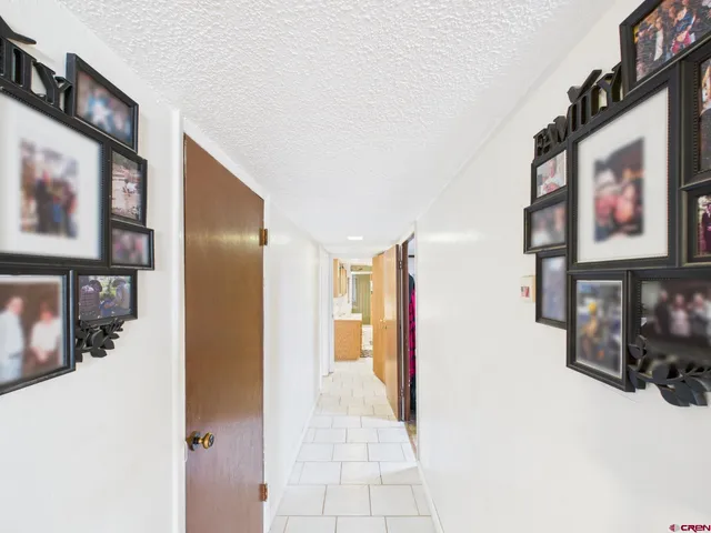 a view of a hallway with paintings on the wall